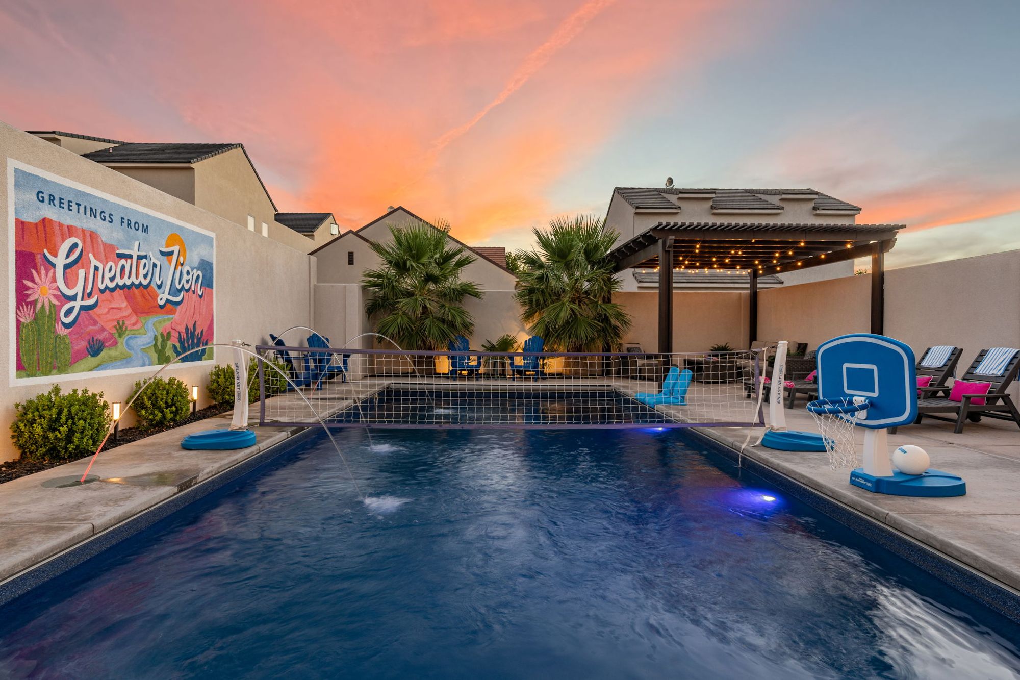 The pool and Greater Zion mural at sunset at Zion Postcard House