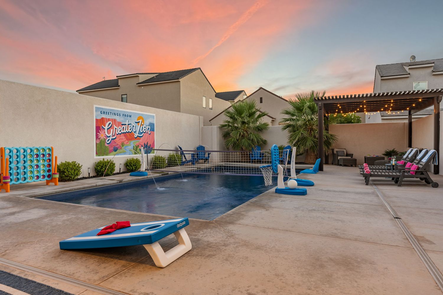 Pool and cornhole at dusk at Zion Postcard House